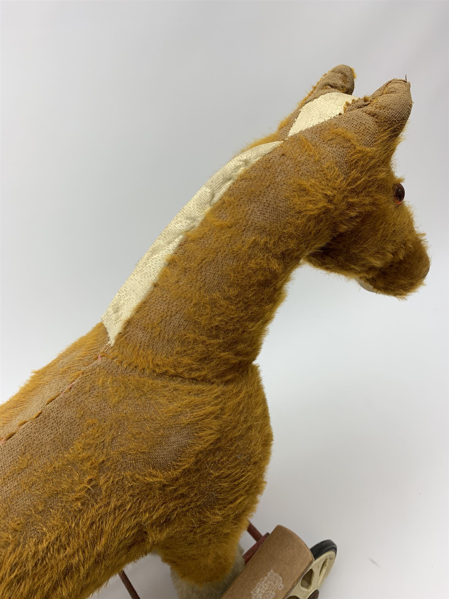 Pedigree push along plush covered horse 1950s-60s with red tubular metal framework and beech foot rests H25