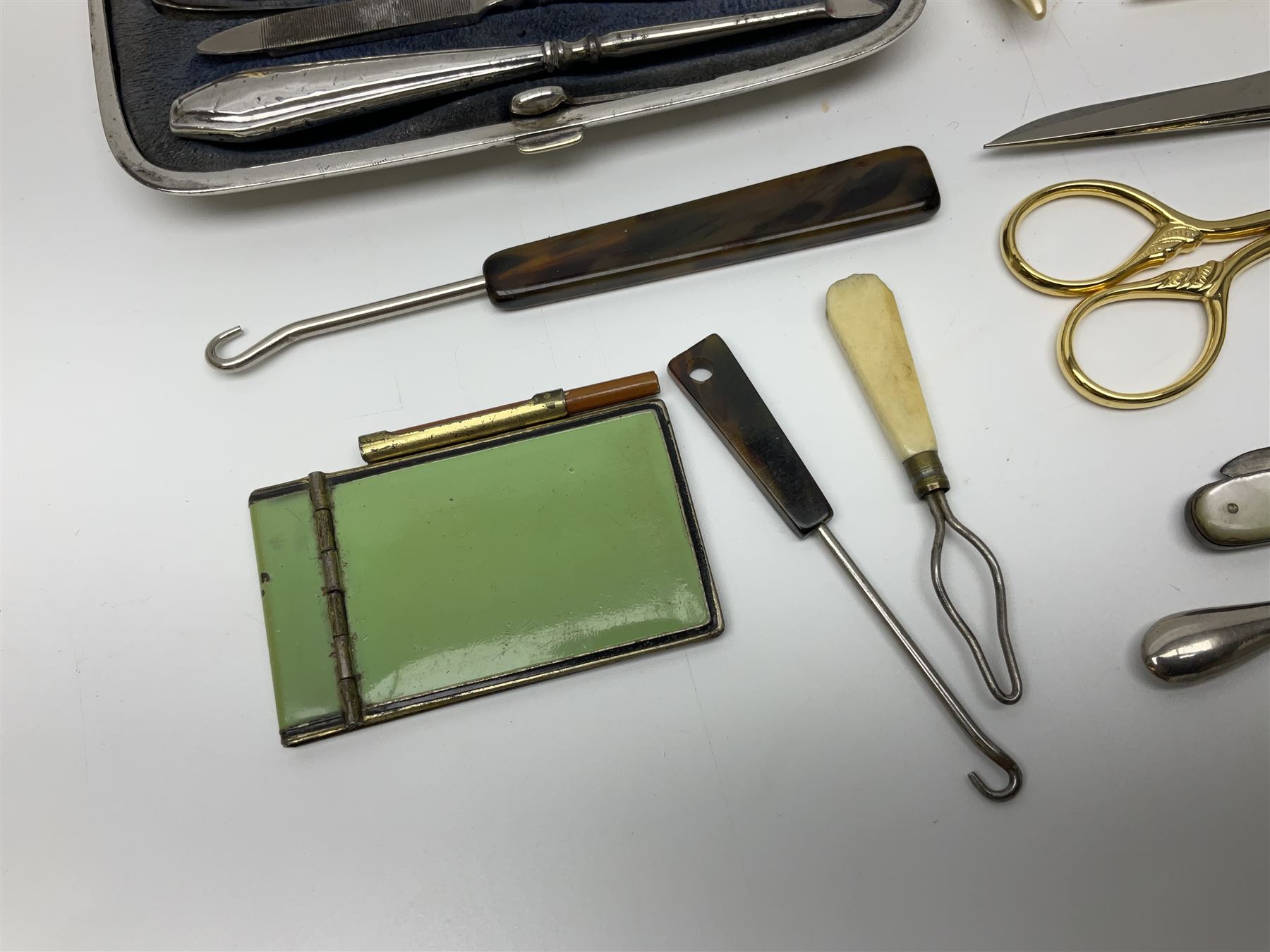 Pair of Wedgewood jasperware unicorn cufflinks, silver handled part manicure set, enamel flip notebook, dolls leather gloves, Stratton compact, and a collection of sewing accessories including thimbles, button hooks, thimble holder, scissors etc 