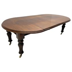 Victorian mahogany extending dining table, circular telescopic extending top with moulded edge, two additional leaves, on turned and lobe carved supports with brass and ceramic castors 