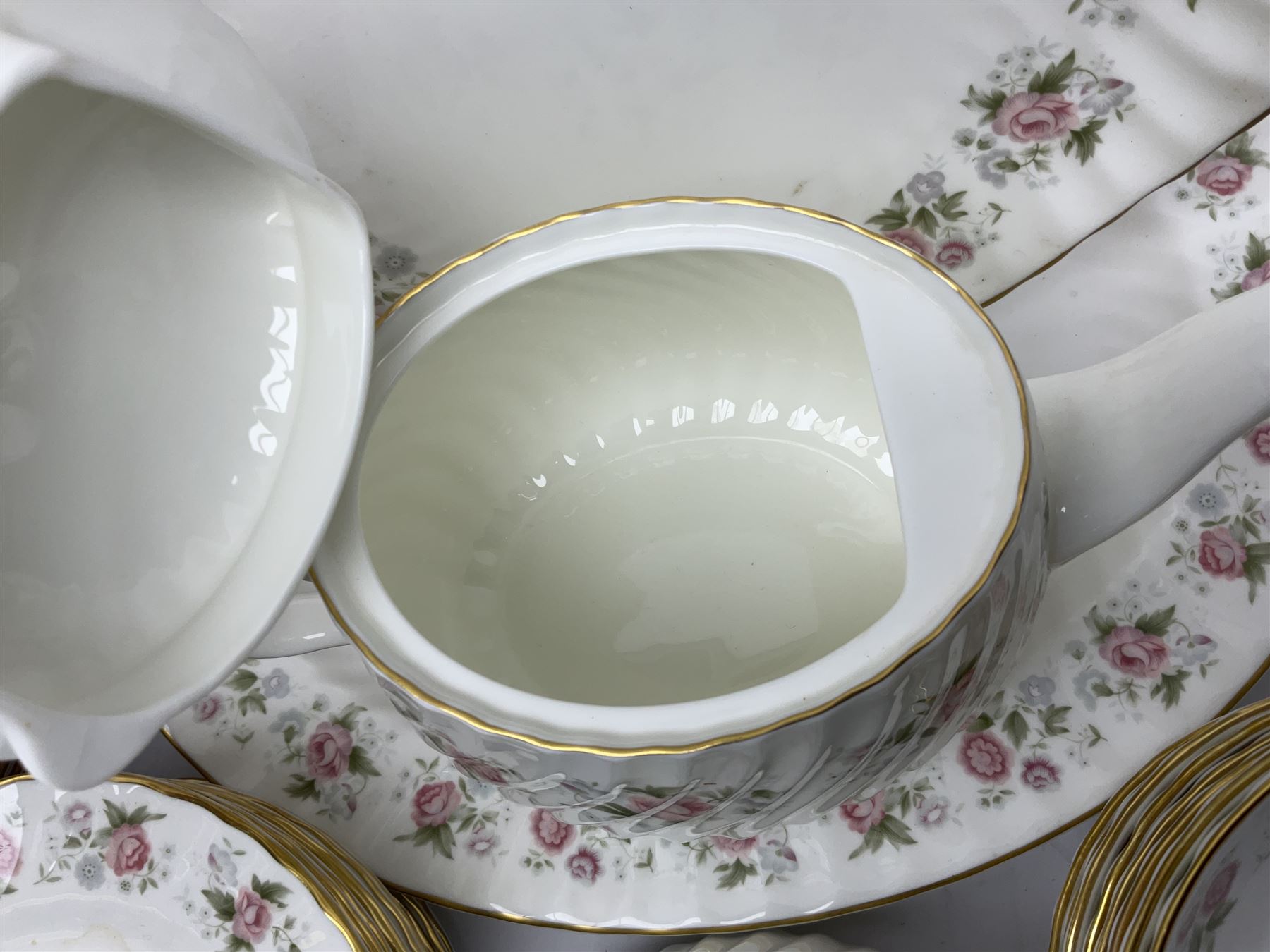 Minton Spring Bouquet pattern dinner and tea service, comprising dinner plates, twin handled tureens with covers, meat platter, teapot, milk jug, sugar bowl with cover, tea cups and saucers, bowls, cake plate, side plates, dessert plates, etc all with printed mark beneath (82)