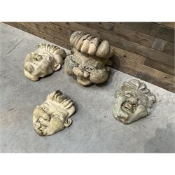 Four grotesque garden wall masks