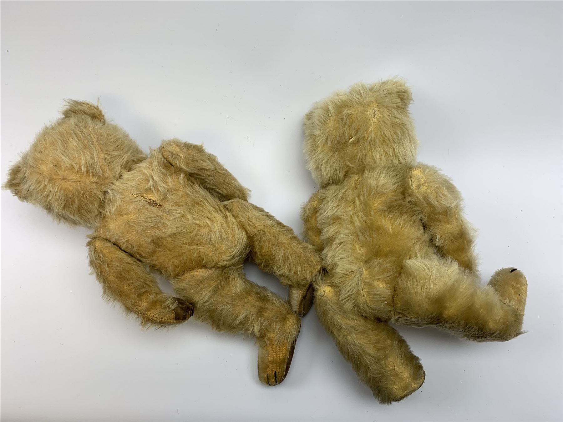 Chiltern Ting-a-Ling teddy bear c1950s with blond mohair body, swivel jointed head with glass eyes and vertically stitched nose and mouth, jointed limbs with velvet pads and card lined feet and internal chimes H14