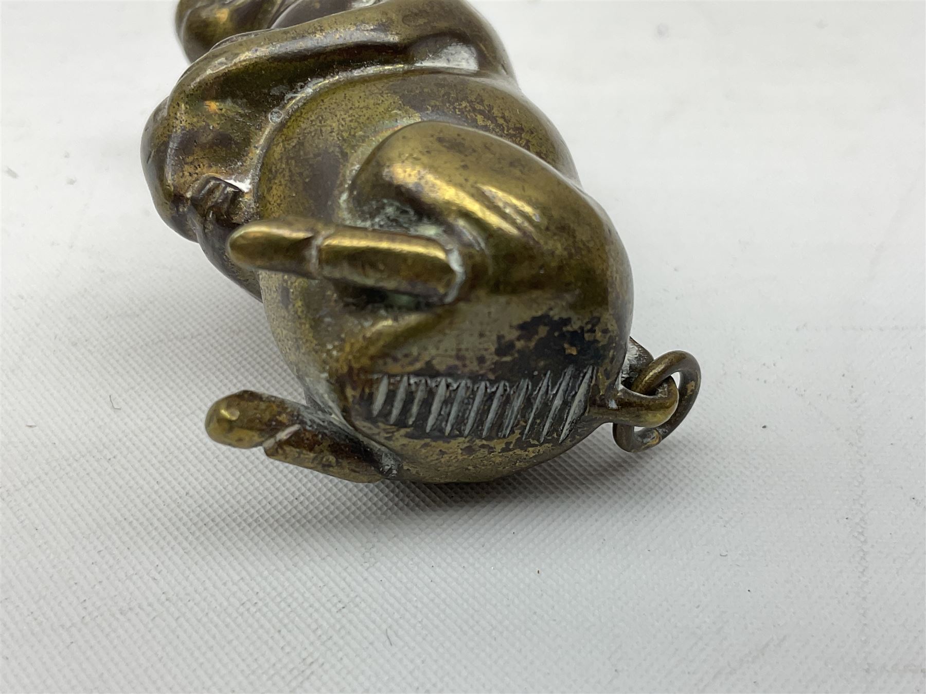 Victorian novelty brass vesta case modelled in the form of a pig holding a money bag, together with a silver vesta, hallmarked 