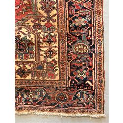 Persian Heriz red ground carpet, the field decorated with all-over geometric floral design...