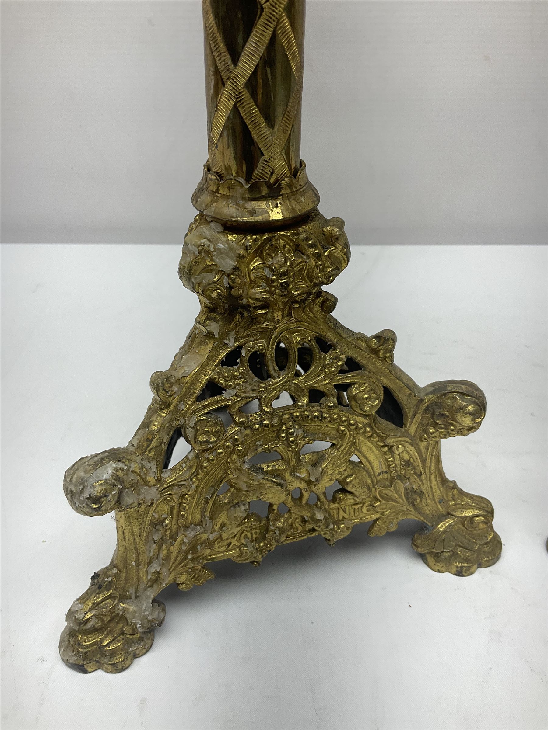 Pair of gilt metal pricket candlesticks, with applied decoration on knopt stems and triform bases, H47cm