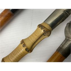 Three swagger sticks - leather covered with spherical terminal embossed with Oman Muscat emblem L68cm; cane carved NAN, the metal terminal with RFC emblem; and malacca cane with spherical terminal embossed with regimental garter crest (3)