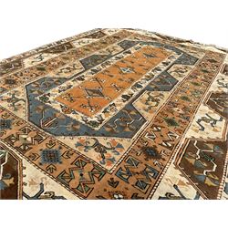 Turkish ivory ground rug, central amber field with lozenges and stylised flower motifs, surrounded by multiple bands with overall geometric design 
