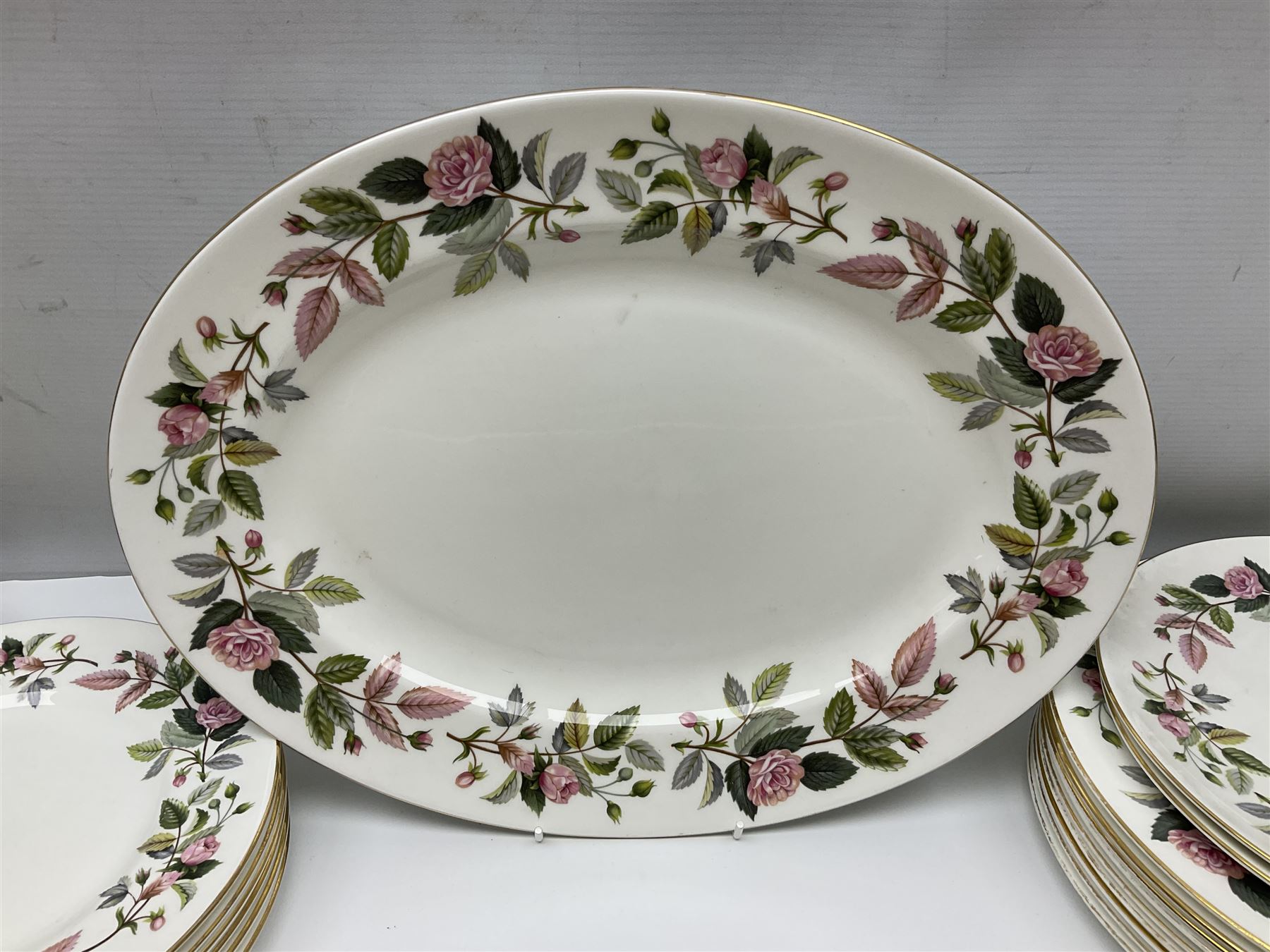 Wedgwood Hathaway Rose pattern tea and dinner wares, comprising twelve saucers, sixteen teacups, twenty tea plates, jug, sucrier, thirteen shallow bowls, sauce boat and saucer, two lidded tureens, larger jug, ten dinner plates, nine smaller plates and two large oval serving dishes