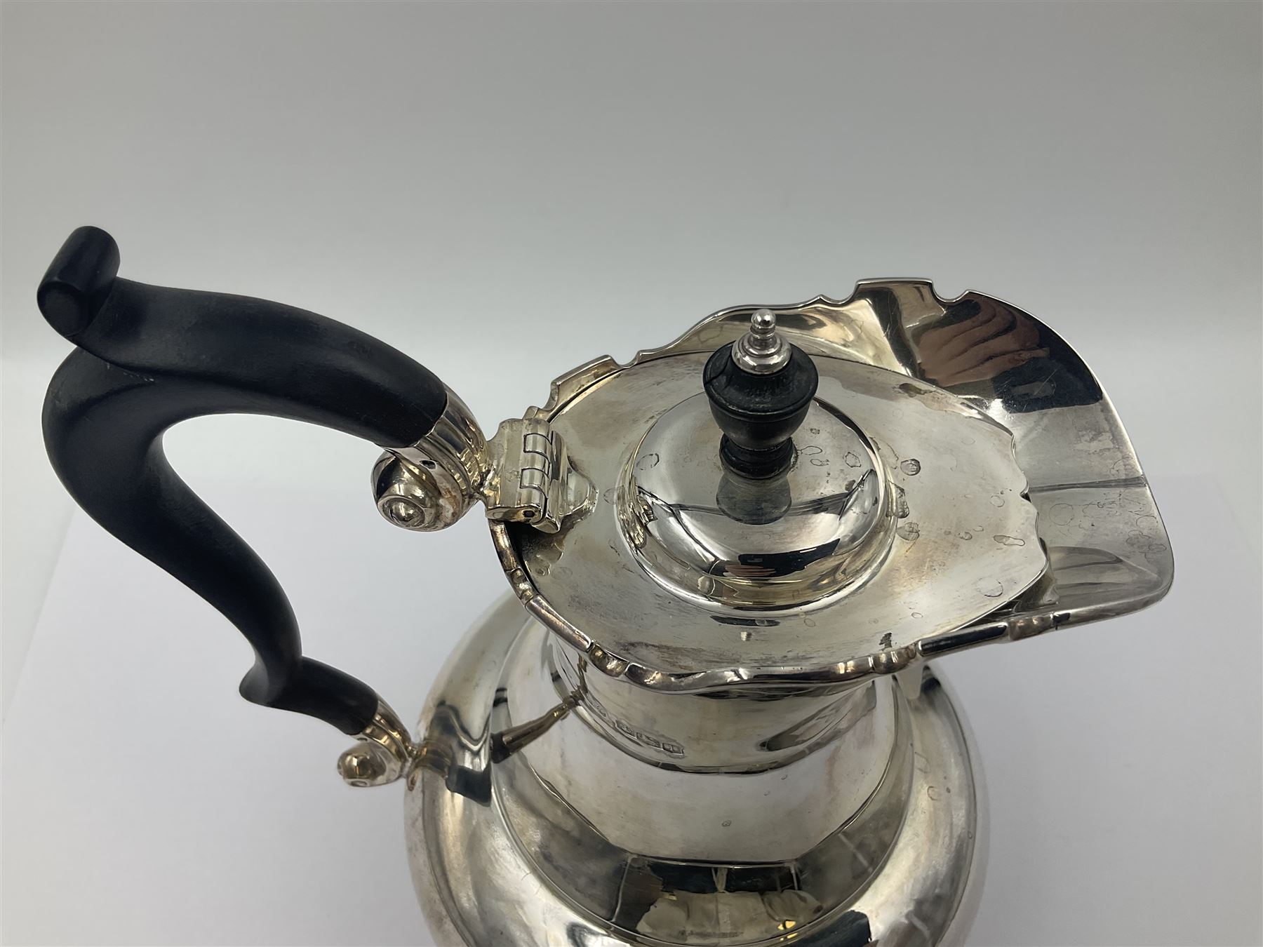 1920s five-piece silver tea service, comprising teapot, coffee pot, hot water pot, twin handled open sucrier and milk jug, each of squat circular form with shaped rim, the teapot, coffee pot and hot water pot each with ebonised handle and finial, the sucrier and milk jug with acanthus capped scroll handles, all upon circular foot, hallmarked R F Mosley & Co, Sheffield 1926 & 1927, tallest H24cm