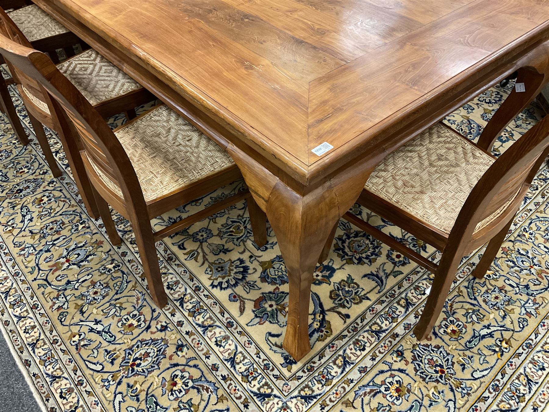 Large teak dining table, moulded rectangular top, on cabriole supports, together with a set of ten ladder back dining chairs with cane work seats