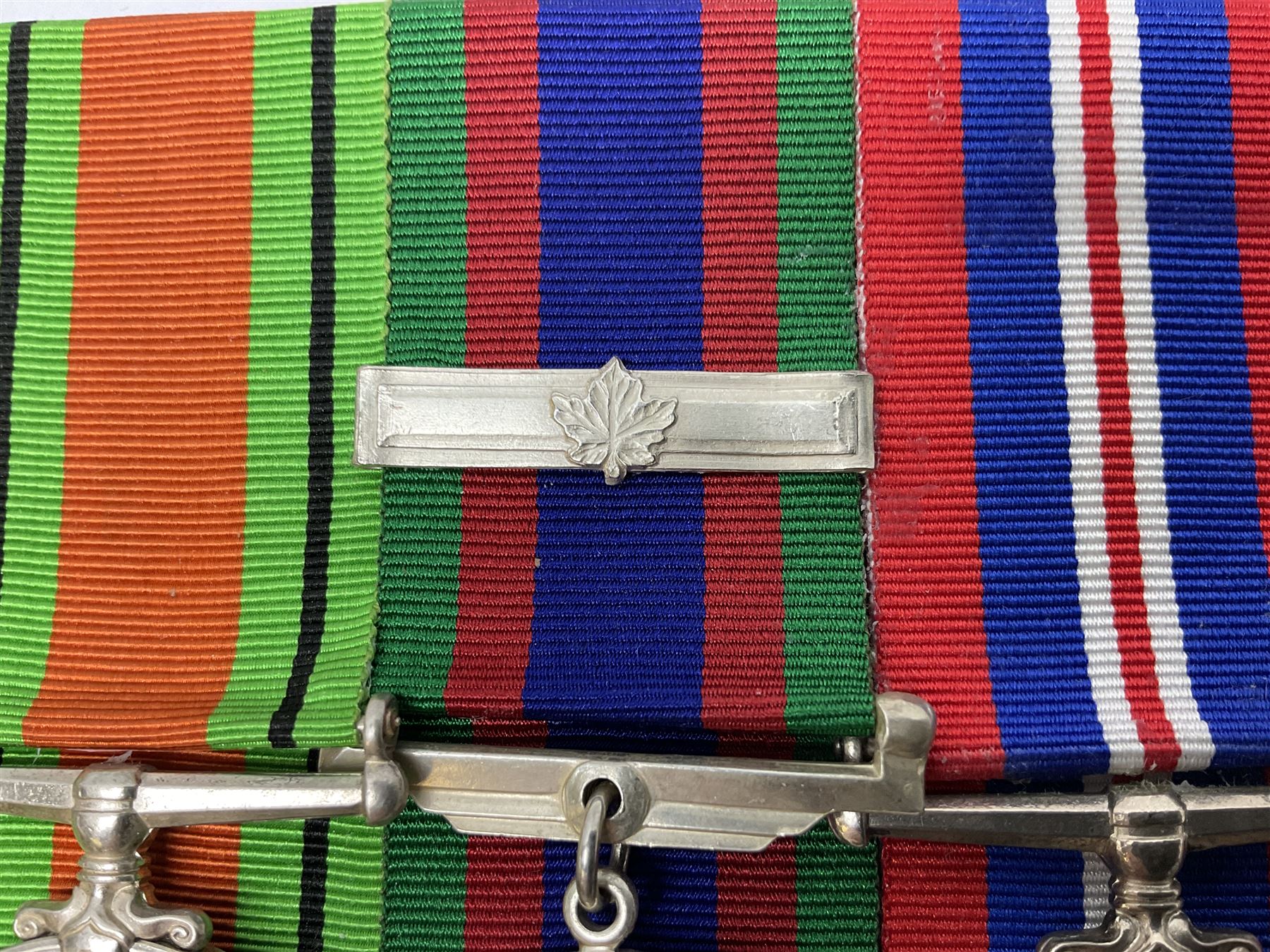 Group of five medals comprising 1939-1945 War Medal, Defence Medal, 1939-1945 Star, Air Crew Europe Star and Canadian Volunteer Service Medal with maple leaf clasp; all with ribbons and mounted on a display board