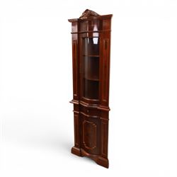 Victorian design mahogany corner cabinet, shaped carved cresting above bowed glazed upper door, with panelled side uprights, lower drawer over cupboard door decorated with floral marquetry, on plinth base
