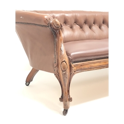 Late 19th century carved walnut framed nailed brown leather  upholstered Chesterfield sofa, with deep buttoned back, leaf carved scroll arms and moulded frieze on scroll carved cabriole legs, W233cm,  H80cm, D90cm  