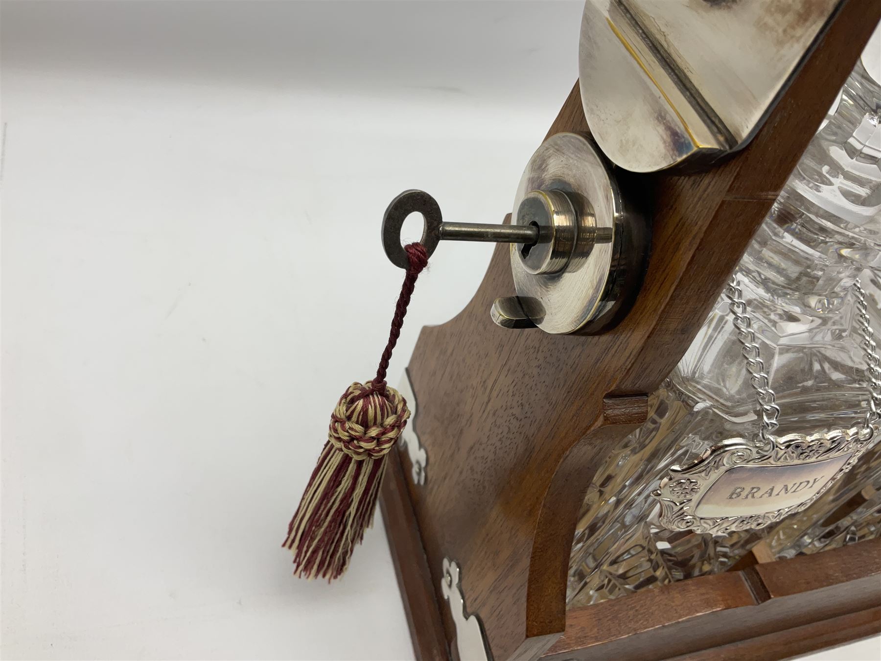 Edwardian silver plate mounted oak tantalus, containing three square sided cut glass decanters, complete with key, H33cm