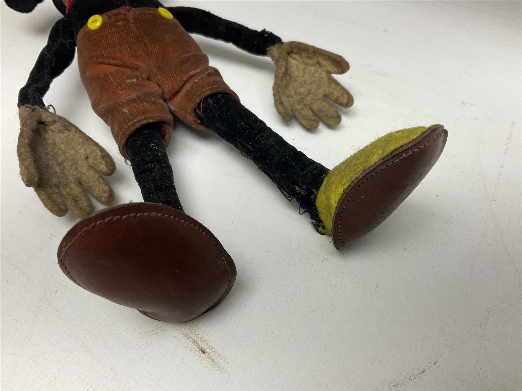 Deans Rag Book Mickey Mouse soft toy, circa 1930's, black velveteen head and body, with cream face and hands, red shorts and yellow felt shoes, marked Reg. No. 750811 to neck H19cm