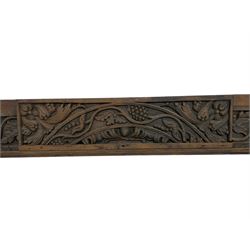 19th century Jacobean Revival oak fire surround, decorated with applied carved panels depicting foliate patterns and stylised grape vines, uprights carved with fleur-de-lis decoration
