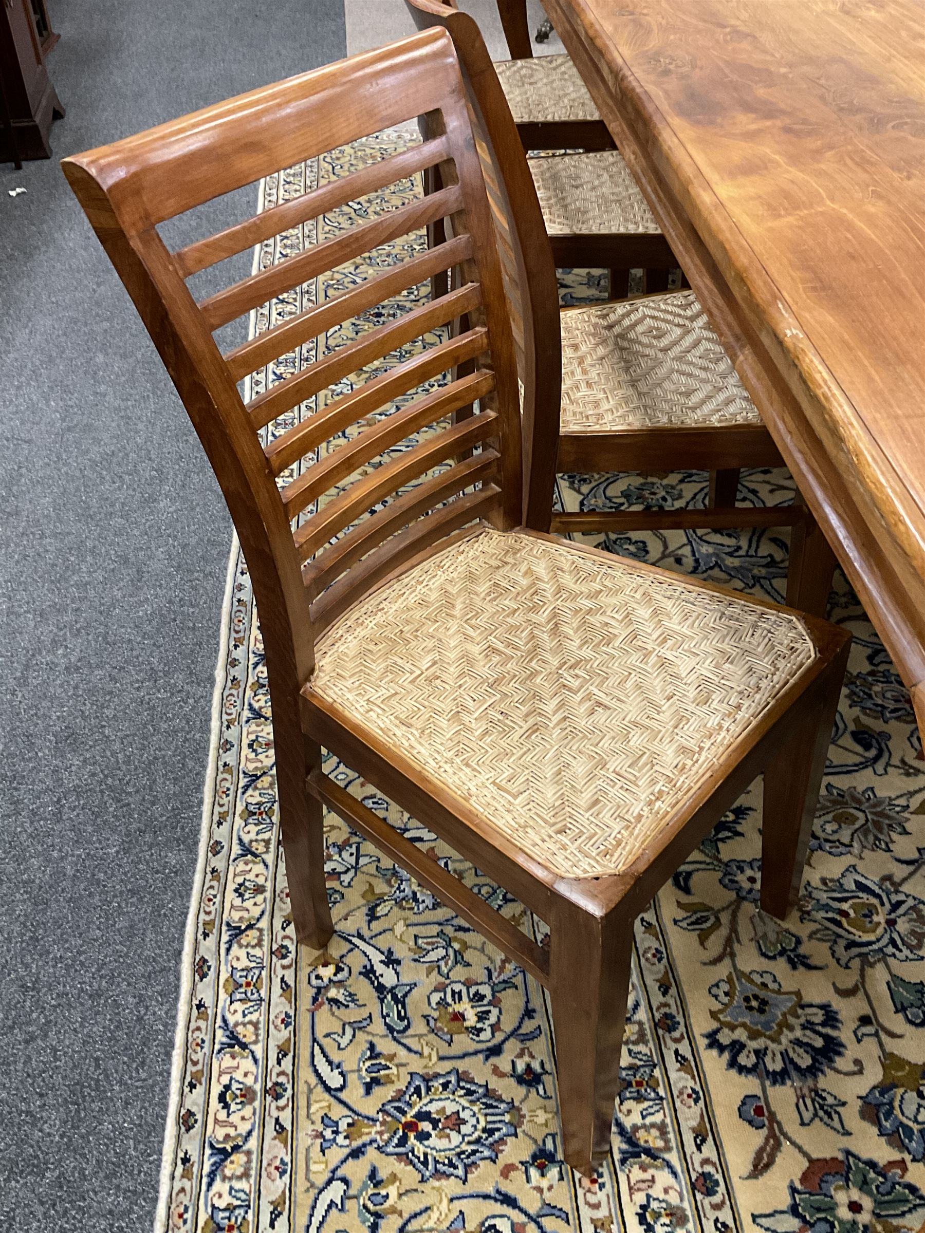 Large teak dining table, moulded rectangular top, on cabriole supports, together with a set of ten ladder back dining chairs with cane work seats
