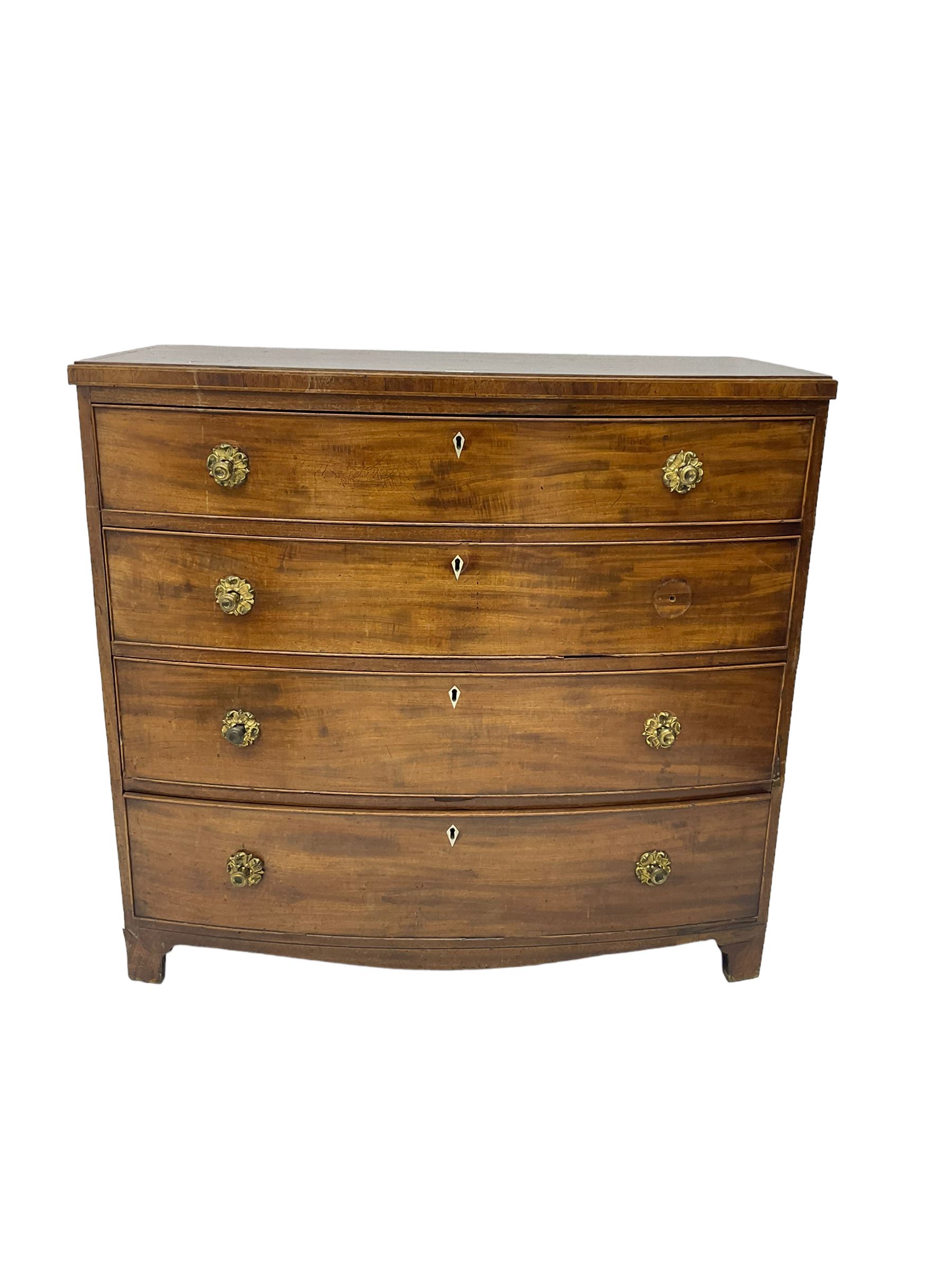 Regency mahogany bow front chest, the top with ebony and satinwood stringing, fitted with four cockbeaded drawers with brass pull handles and bone escutcheons, on bracket feet