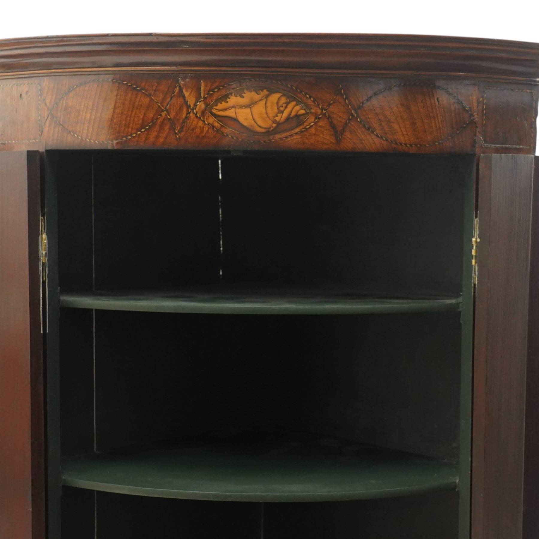 Georgian inlaid walnut cylindrical corner cupboard, projecting cornice over a banded frieze with inlaid shell motif, enclosing three shelves with two spice drawers fitted to base