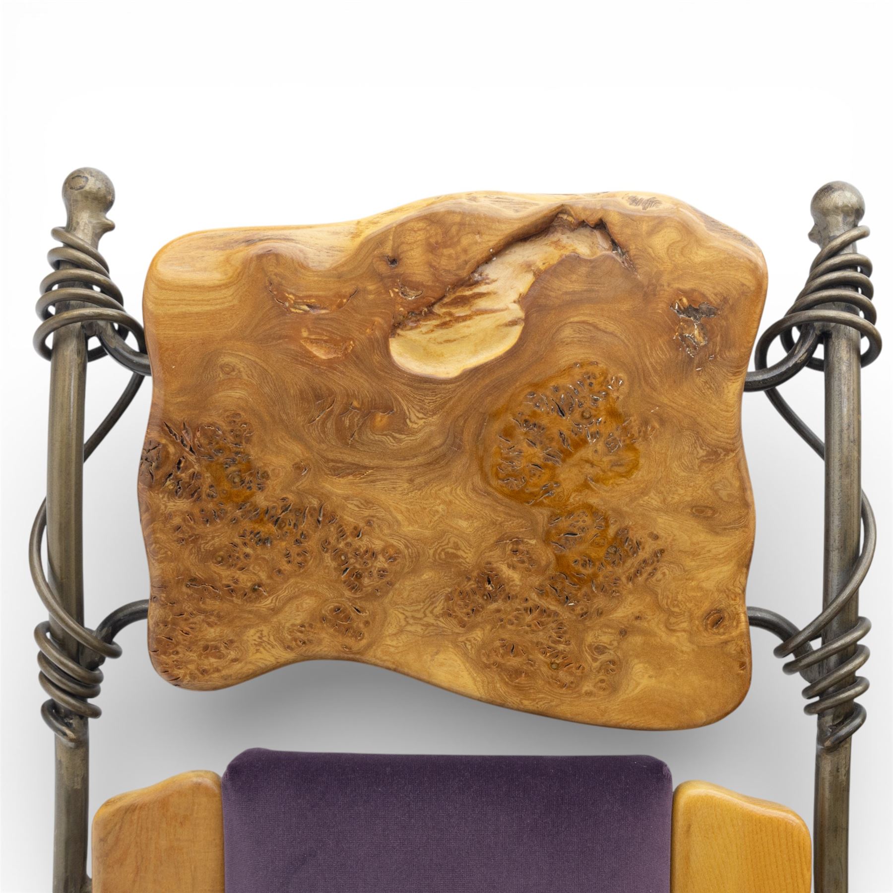 Paul Hodgkiss Designs of Glasgow - contemporary shaped elm dining table with wrought iron base; with set ten (8+2) matching high-back dining chairs, table of organic form above an elaborate wrought iron supports, with central elm stretcher, the chairs with en suite with matching wrought iron work burred elm headrest, purple velour upholstery with drop in seat     

Table: W 102cm, L 243cm, H 74cm
Chairs: W 56cm, D 52cm, H 130cm