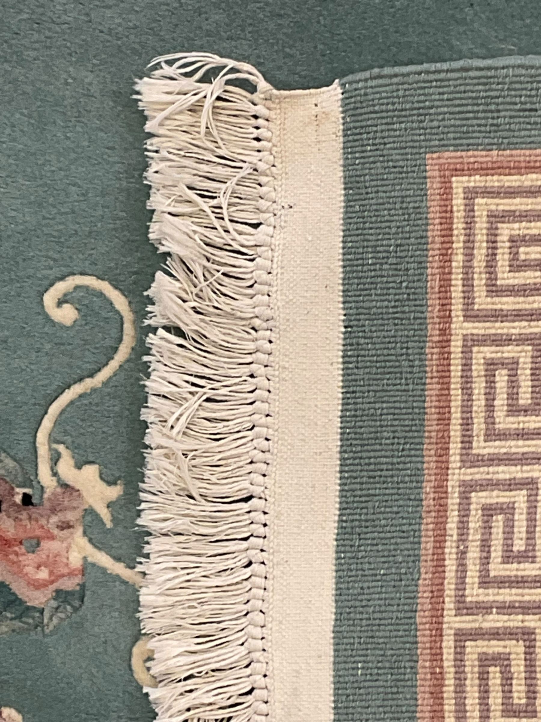 Chinese jade ground woollen rug decorated with dragons 