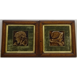  Pair late 19th century relief moulded portrait tiles, decorated with a young man and woman in profile, probably by J&W Wade & Co. within period oak fames with gilt slip & plush mounts, 34cm x 34cm overall (2) Provenance: From a Private Yorkshire Collector  