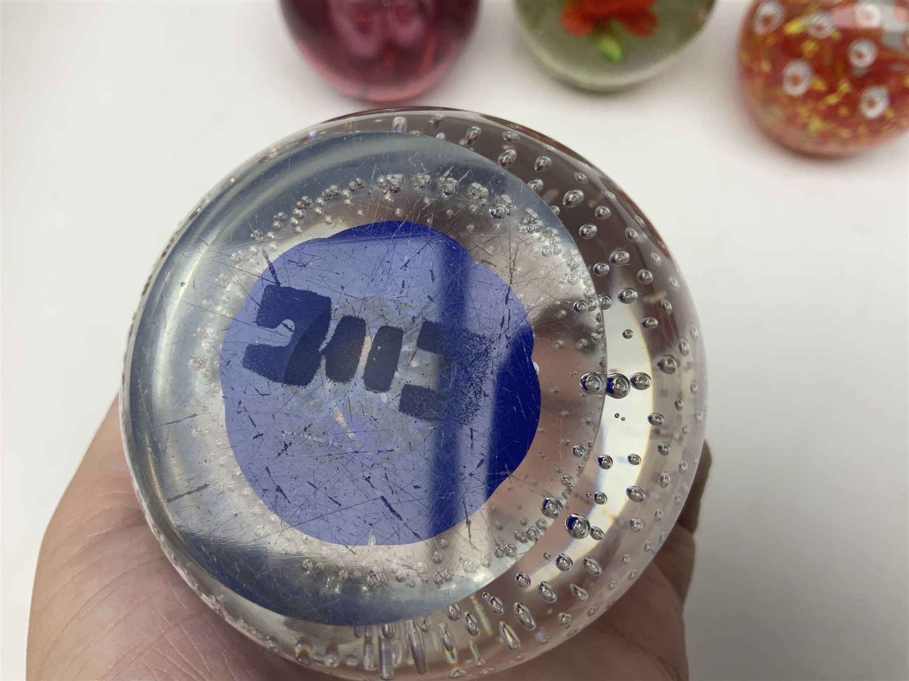 Collection of glass paperweights, to includes examples with internal air bubble inclusions and ones with internal flowers (11)