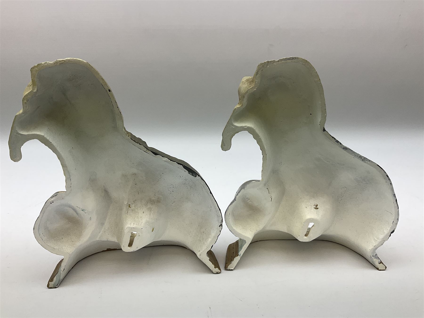 Pair of cast iron Dulux Old English sheepdog doorstops together with another modelled as a golfer