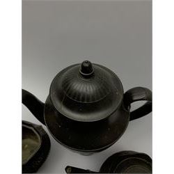 Early/mid 19th century black basalt tea wares, comprising large coffee pot, with engine turned decoration to the body and cover, H27.5cm, osier moulded teapot with widow finial, osier moulded cream jug, and silver shape sucrier 