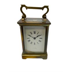 An early 20th century French timepiece carriage clock in a Corniche case with a white enamel dial , Roman numerals, decorative steel hands and minute markers, four bevelled glass panels and a rectangular panel to the top, with a replacement jewelled lever platform escapement with timing screws.
