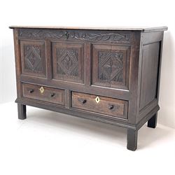 18th century oak blanket mule chest, rectangular moulded hinged lid, the frieze carved with trailing foliage and flower heads, triple fielded panelled front each carved with floral lozenge, the left panel carved with thistles,  panelled sides, two drawers below, stile supports with applied lower mould