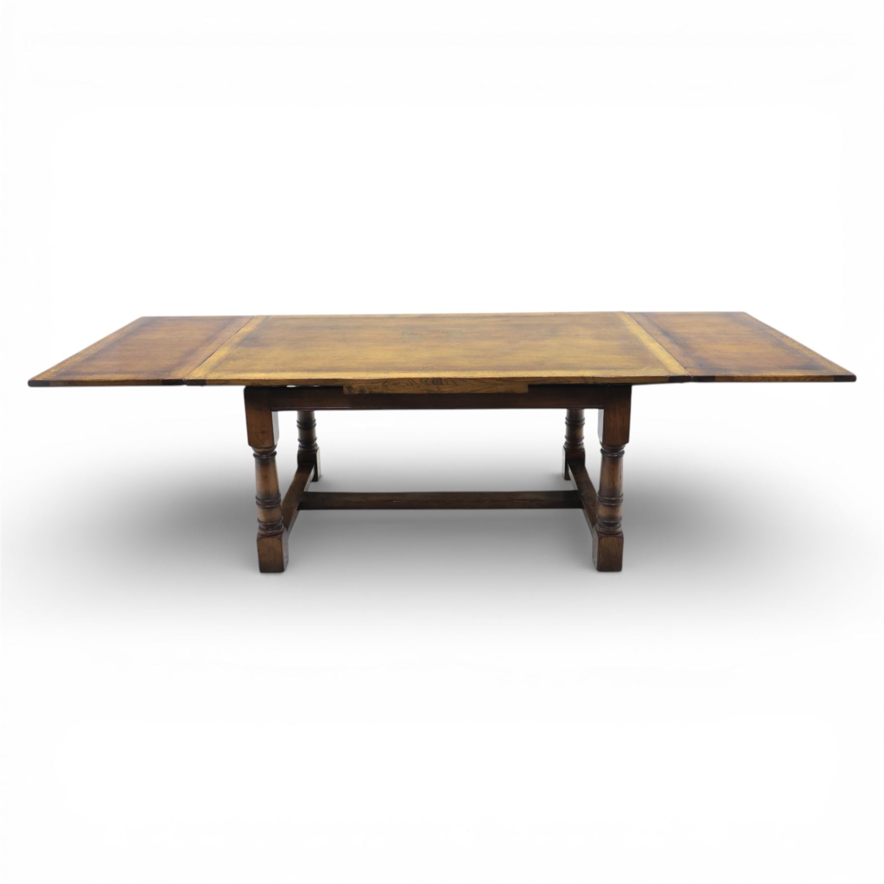Titchmarsh & Goodwin - stained oak draw leaf dining table, raised on turned supports with H-stretcher, extends to 273cm