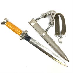 WW2 German Deutsches Rotes Kreuz (Red Cross) Leader's dagger with unmarked 24.5cm double edged steel blade, white metal hilt with cut-down oval langet and ribbed orange plastic grip, the hammered white metal scabard with slightly off-set square suspension rings and silvered/silver thread hanging straps L39cm