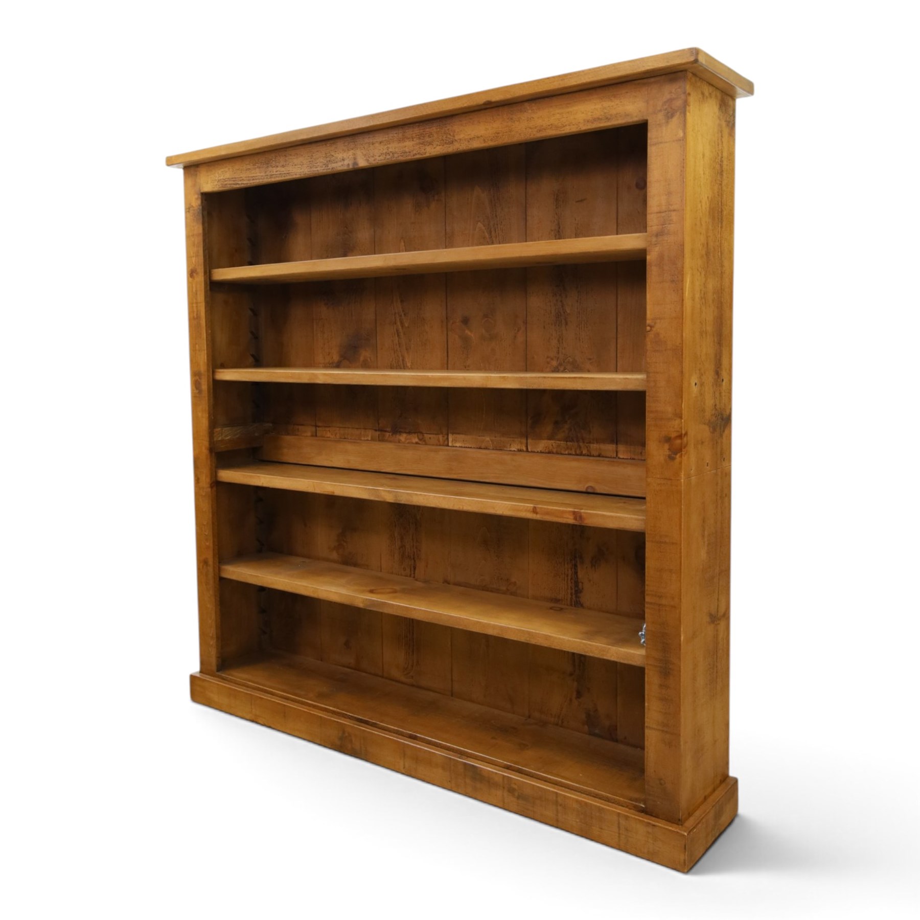 Indigo Furniture - large rustic oak open bookcase, with four adjustable shelves, above a plinth base 