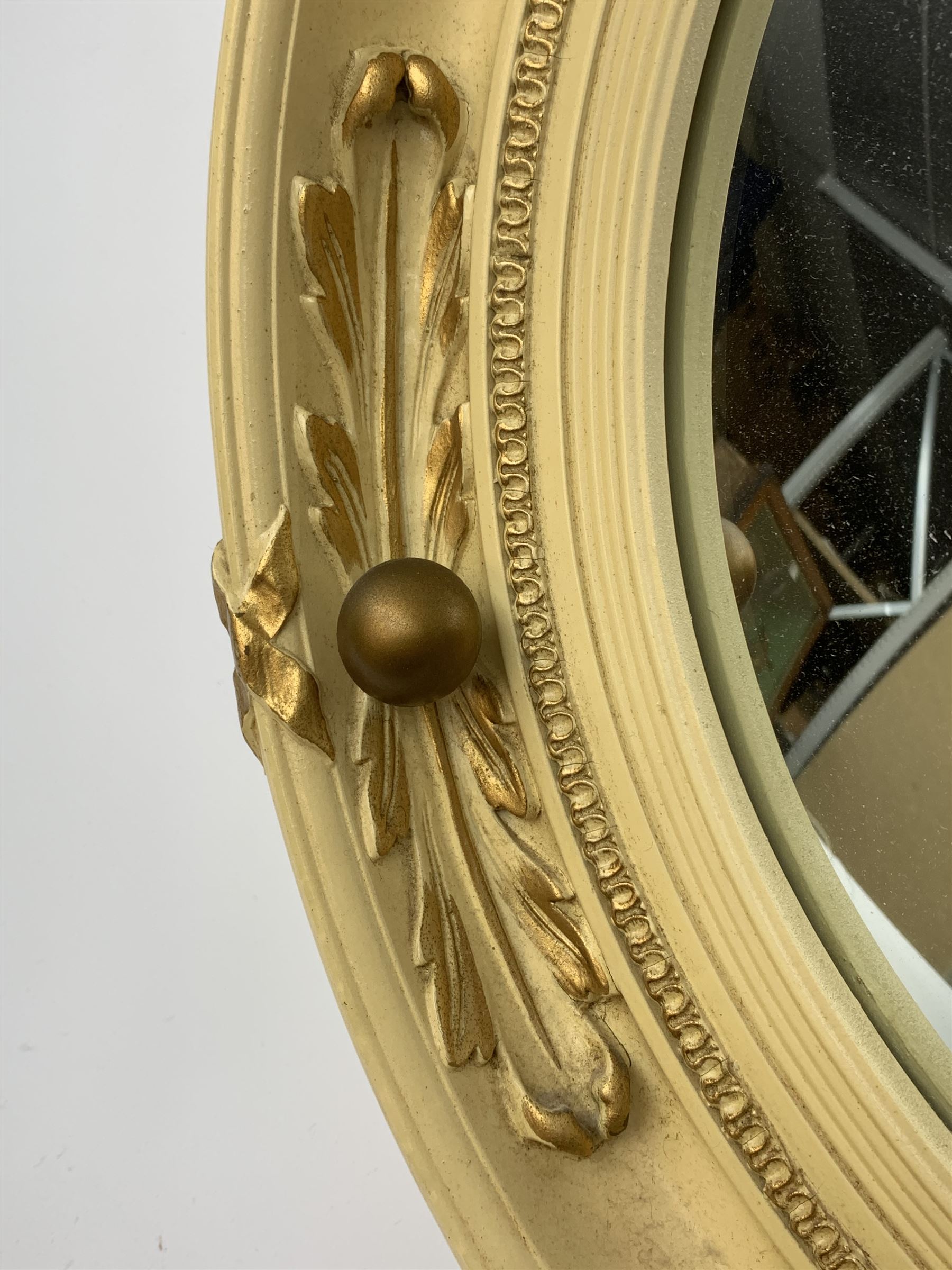 A vintage Atsonea convex mirror, of circular form, the cream frame with gilt detail, D41.5cm.