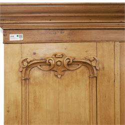 Late 19th century pine wardrobe, with stepped cornice over triple panelled doors, applied foliate carvings to outer panels, raised over a separate pine plinth drawer with moulded facia and twin glass pulls
