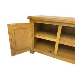 Light oak TV or media cabinet, rectangular top over single open shelf flanked by two cupboards