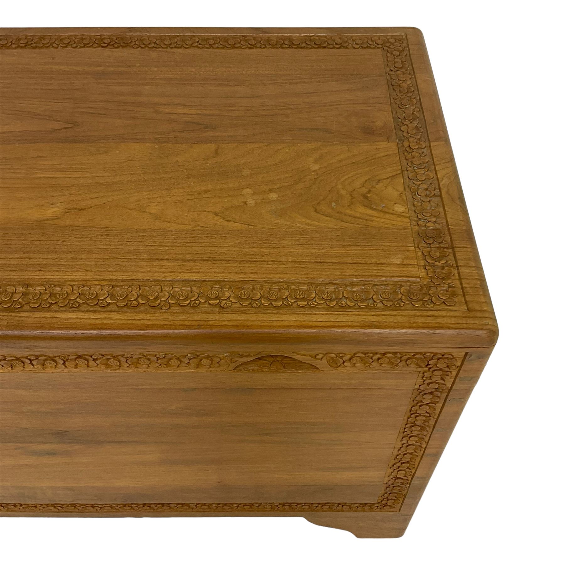 Mid-to-late 20th century Singapore camphor wood blanket chest, the hinged lid and front decorated with flower head carved bands