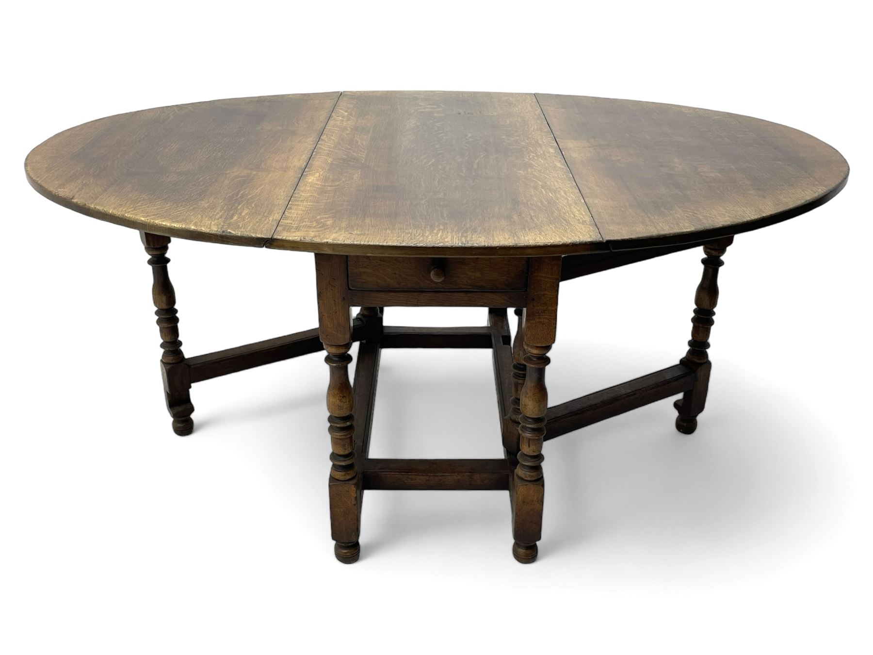 19th century oak dining table, oval drop-leaf top on gate-leg action base, turned supports united by turned stretchers, fitted with single end drawer