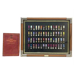 Limited edition large framed display board with sixty half-size copies of British Gallantry and Campaign Medals produced by Danbury Mint; all with ribbons and associated booklet