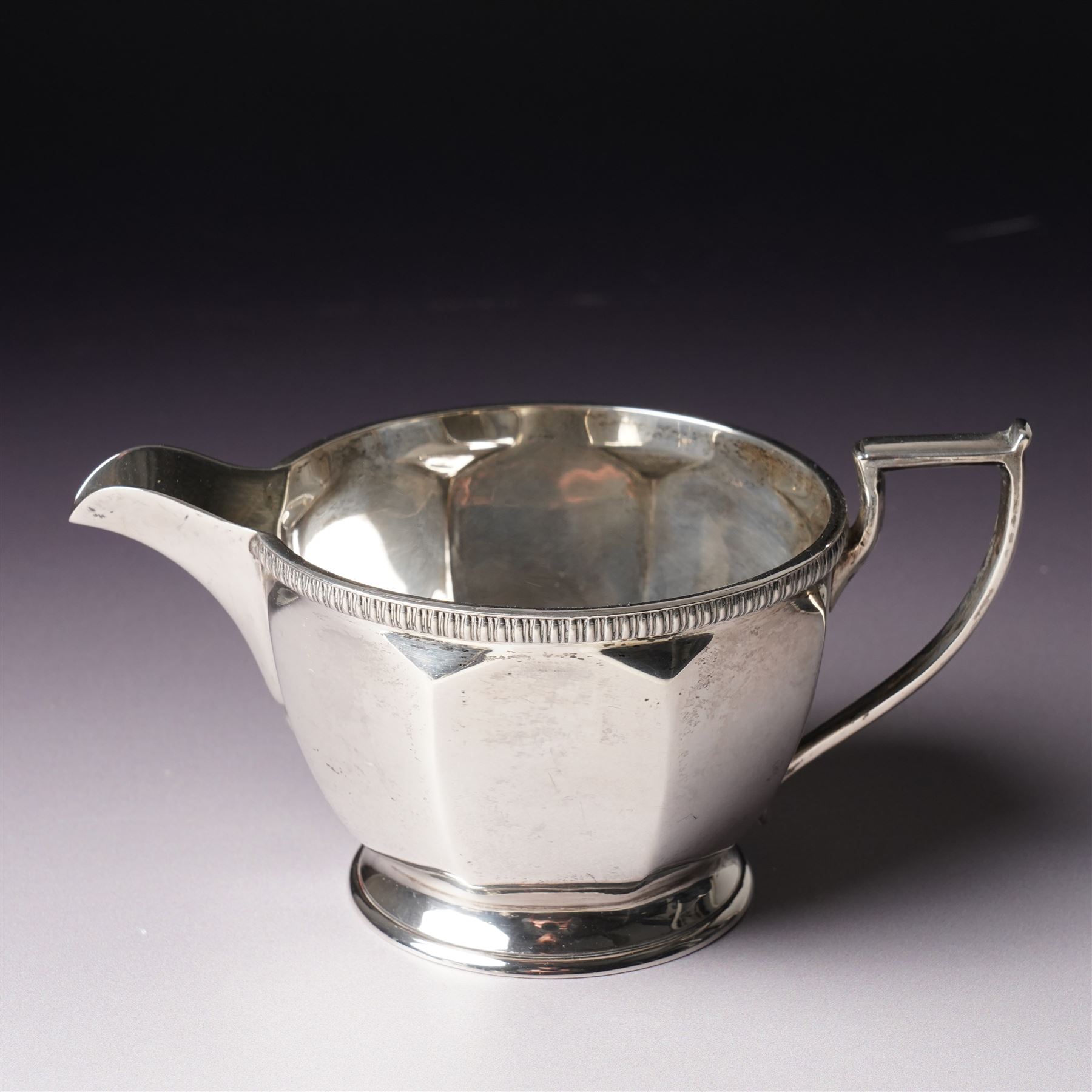  Silver tea set comprising teapot, hot water jug, sugar bowl and milk jug of circular panel sided design Sheffield 1941 Maker Harrison Brothers & Howson 