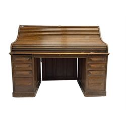 Cutler - early 20th century American oak tambour roll-top desk, the twin pedestals fitted with four graduating drawers