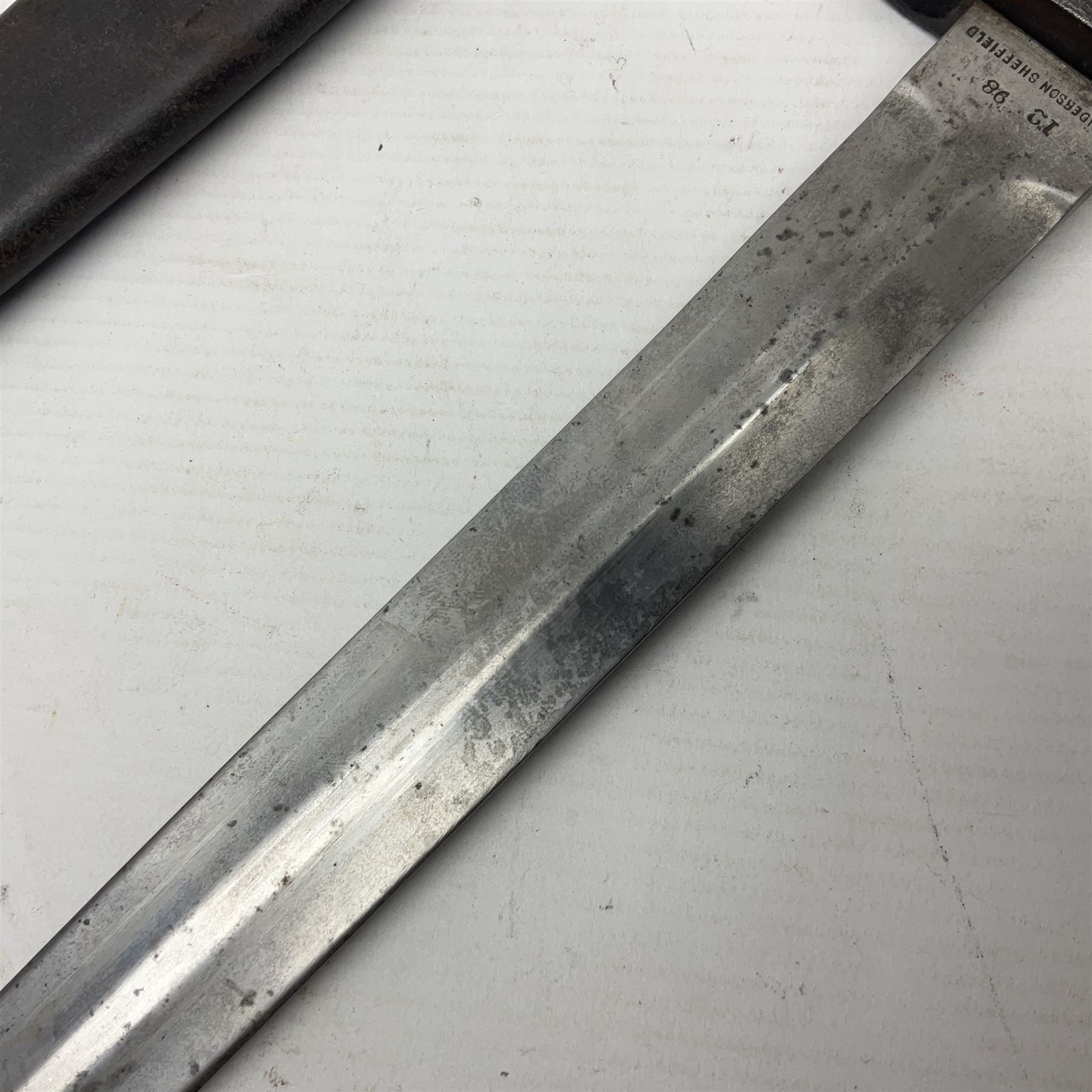 British Pattern 1888 knife bayonet, the 30cm double edged blade by Sanderson with central raised medial ridge and various marks to the ricasso including date code 12 98; in leather covered scabbard with various stamped marks L44cm overall
