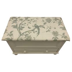 White painted pine blanket box, hinged lid upholstered in light fabric decorated with birds and foliate, fitted with single drawer