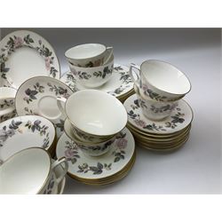 Royal Worcester June Garland pattern tea and dinner wares, comprising thirteen dinner plates, twelve dessert plates, twelve side plates, six twin handled soup bowls and six saucers, six small bowls, sauce boat and stand, thirteen teacups and fifteen saucers, open sucrier, and milk jug