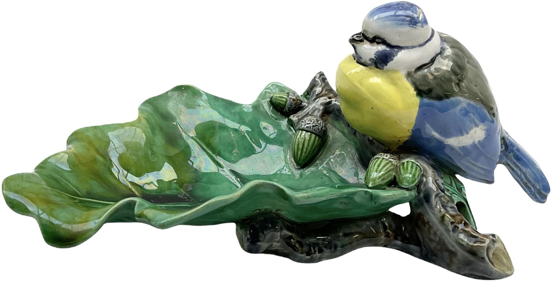 Minton majolica leaf dish, modelled as a Blue Tit perched on a branch with acorns and an oak leaf, date cypher for 1868, impressed marks beneath, L21cm. 