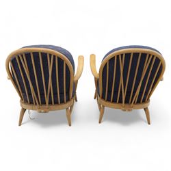 Ercol - Model '203', pair of easy chairs, with blue upholstered cushions and additional orange covers, with looped backrest and shaped spindles, outward swept arms, drop in seat frame