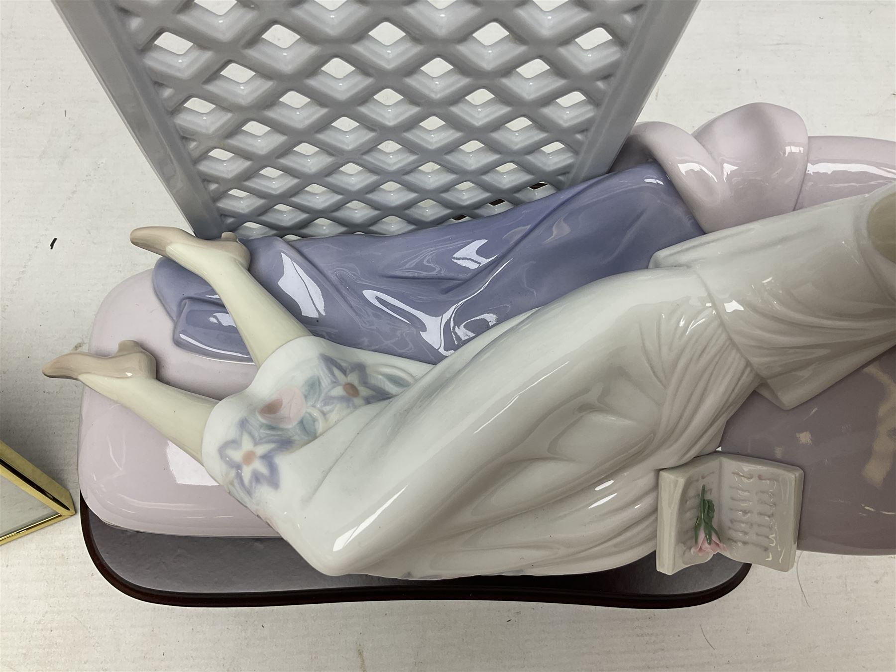 Lladro figure, Garden of Dreams, modelled as a woman reclining in front of trellis of flowers on a mahogany base, limited edition 3129/4000, sculpted by  José Puche, with original box, no 7634, year issued 1994, year retired 1996, H32cm
