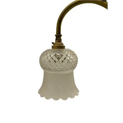 Early 20th century brass rise and fall light fitting, serpentine bar fitted with two branches, with two cut glass shades