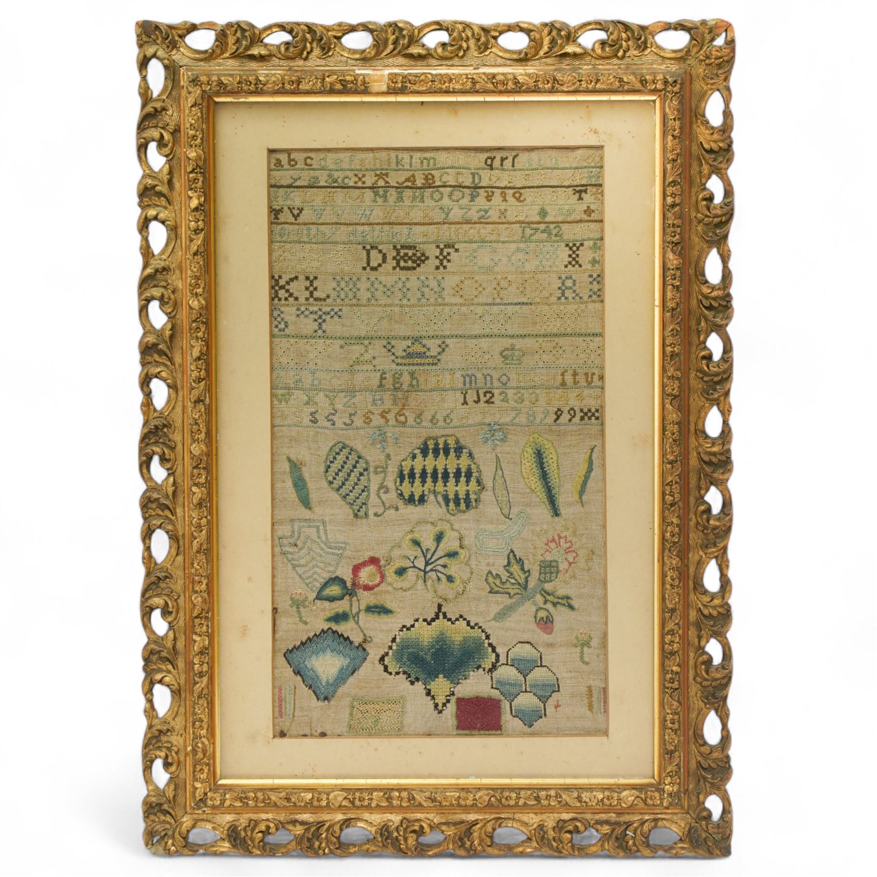 George II sampler, Dorothy Dethick, dated 1742, worked with bands of the alphabet, the lower section finely worked with various floral and foliate motifs, most likely examples of her practicing her technique, contained within ornately carved gilt frame 37.5cm x 21cm 